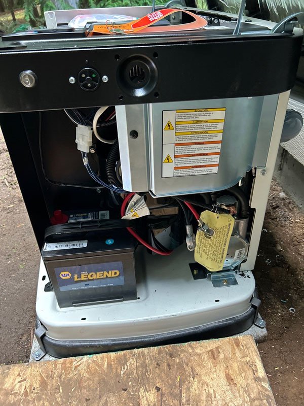 Home generator with open panel for inspection and maintenance